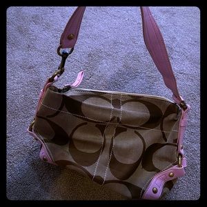 Coach purse with pink detail.